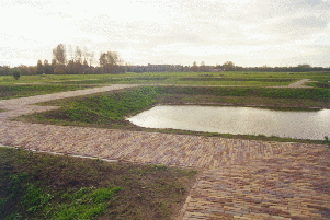 The pathway on an earthen dam marks the foundations of Nieuwburg Castle.